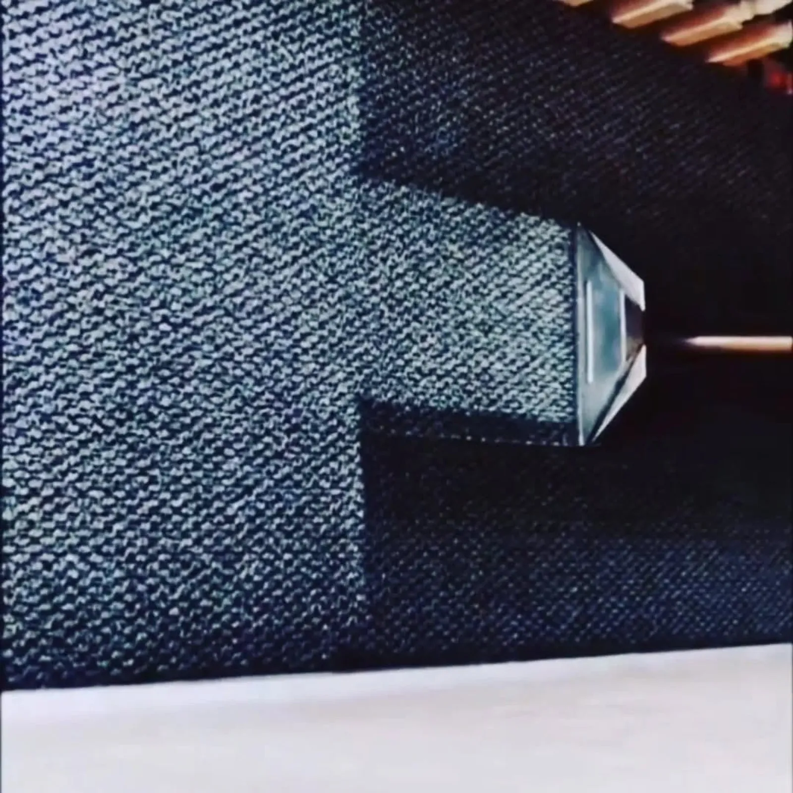 A carpet cleaning wand making a deep extraction pass across dark carpet during a professional clean