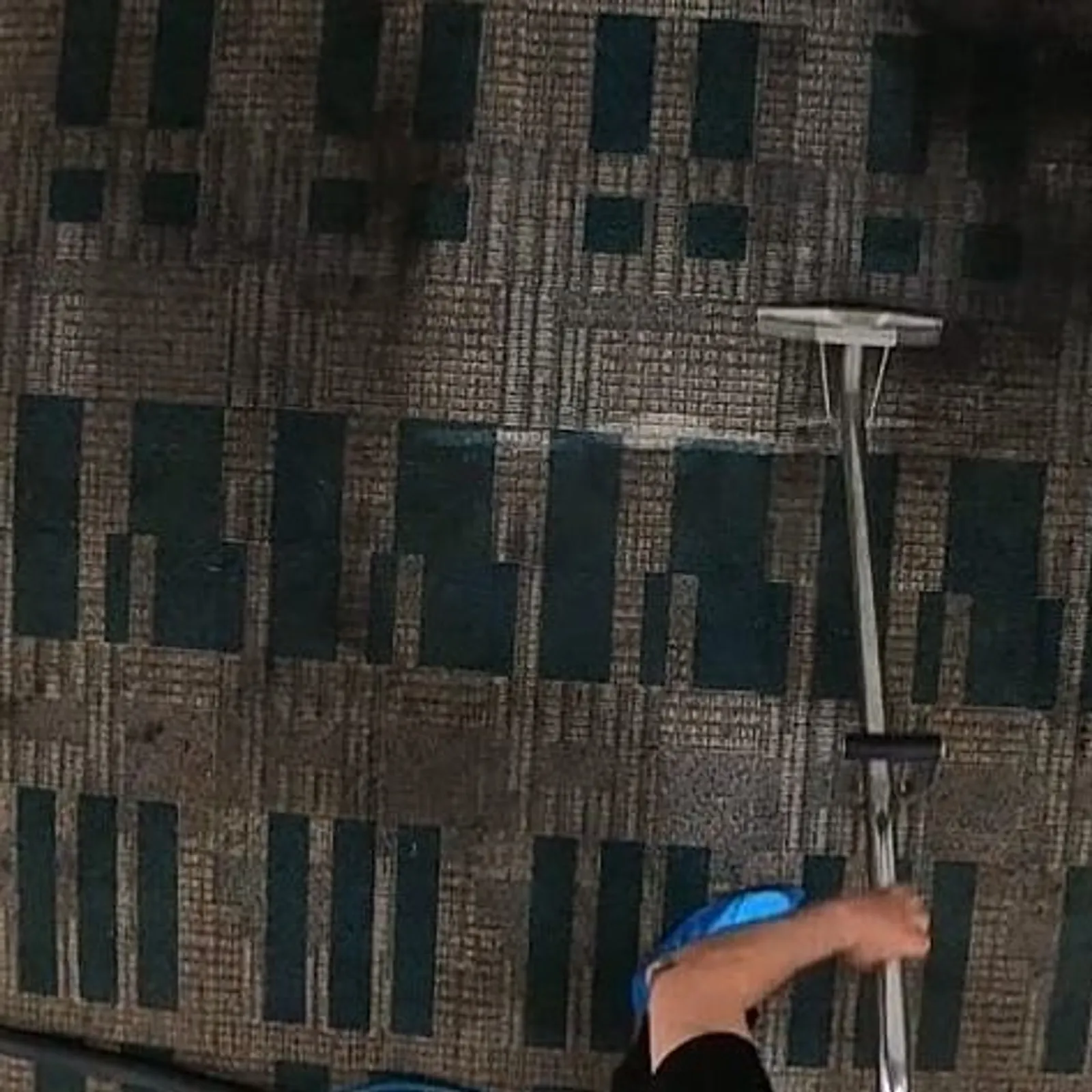 Extraction wand cleaning a patterned commercial carpet tile floor