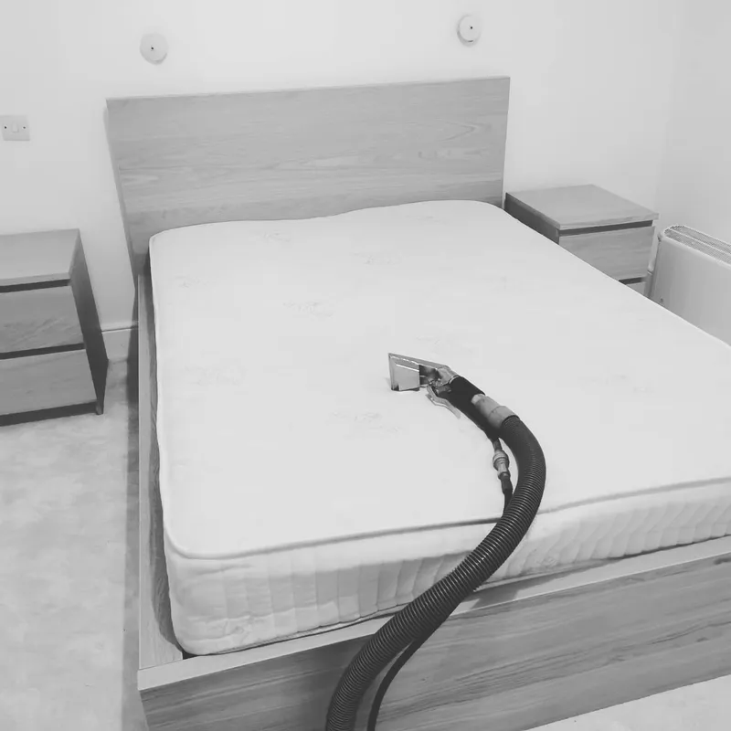 Mattress being professionally cleaned in a bedroom