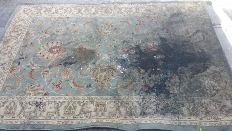 Area rug before cleaning, heavily soiled