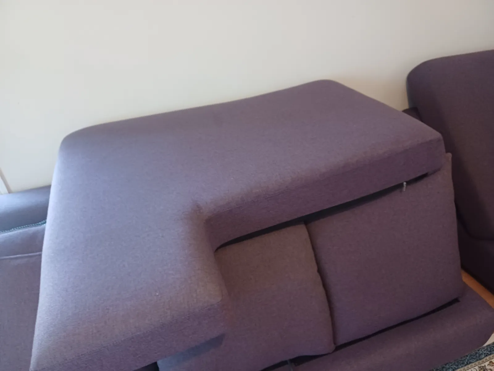 Close-up of a fabric armchair and cushions being assessed before cleaning